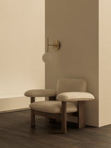 Fauteuil Brasilia dossier bas en ambiance salon avec applique TR Bulb
