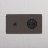 Vue d'ambiance de l'interrupteur et prise Grove bronze installé sur un mur